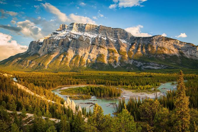 Banff hoodoo rock formations along the Bow River with Mount Rundle in the background