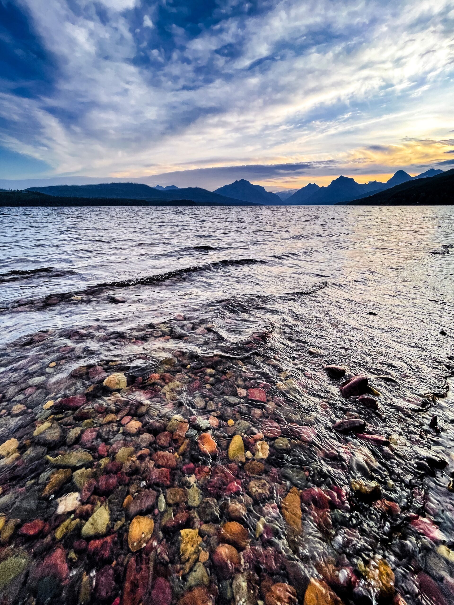 Lake McDonald colorful pebbles at sunrise in Glacier National Park