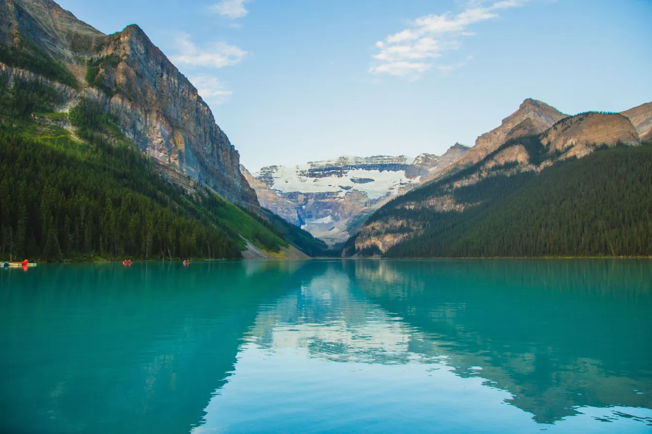Lake Louise turquoise water and canoes with Victoria Glacier in Banff National Park
