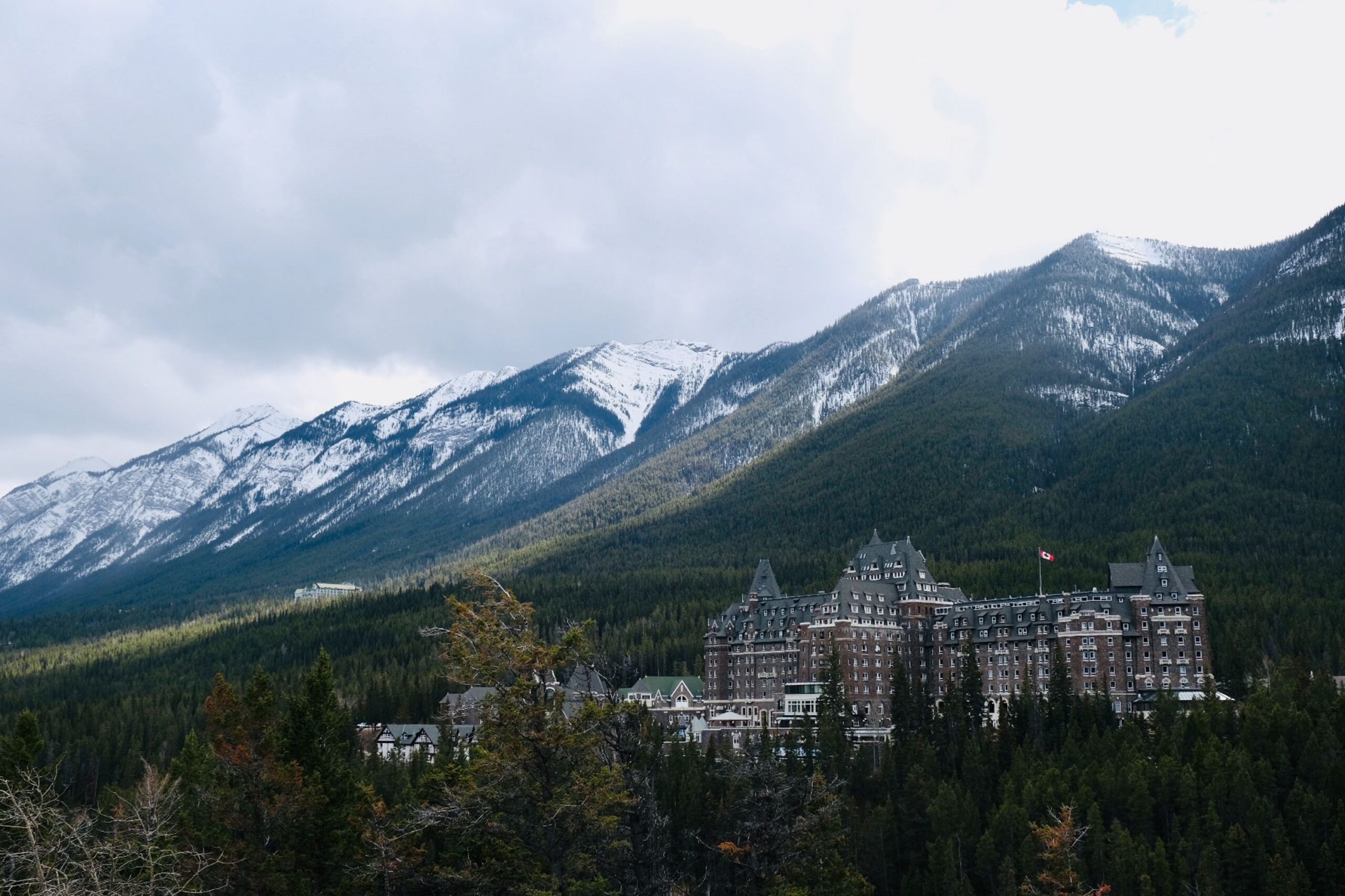 View of the Fairmont Banff Springs Hotel from Surprise Corner, with mountains behind